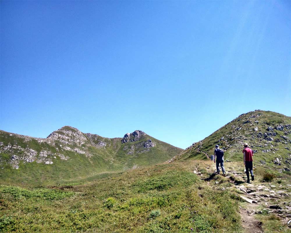 due persone in salita sul sentiero verso libro aperto ad abetone