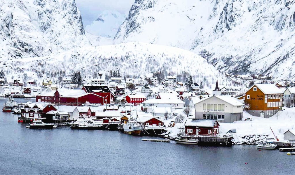 vista innevata del vilaggio di reine sul mare con le montagne sullo sfondo alle isole lofoten norvegia